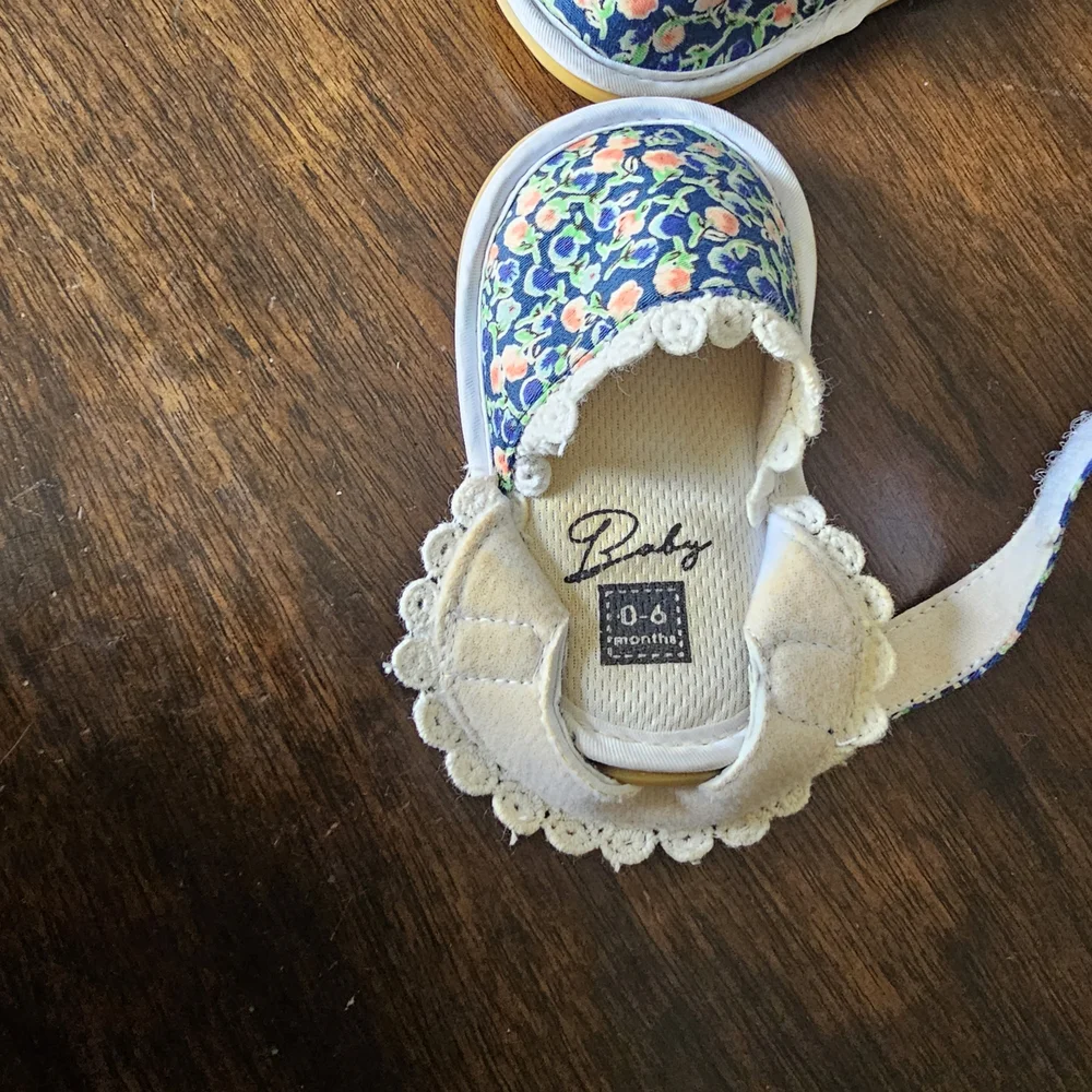 3 pairs of baby/girl shoes—soft, floral, and glittery—in various styles.